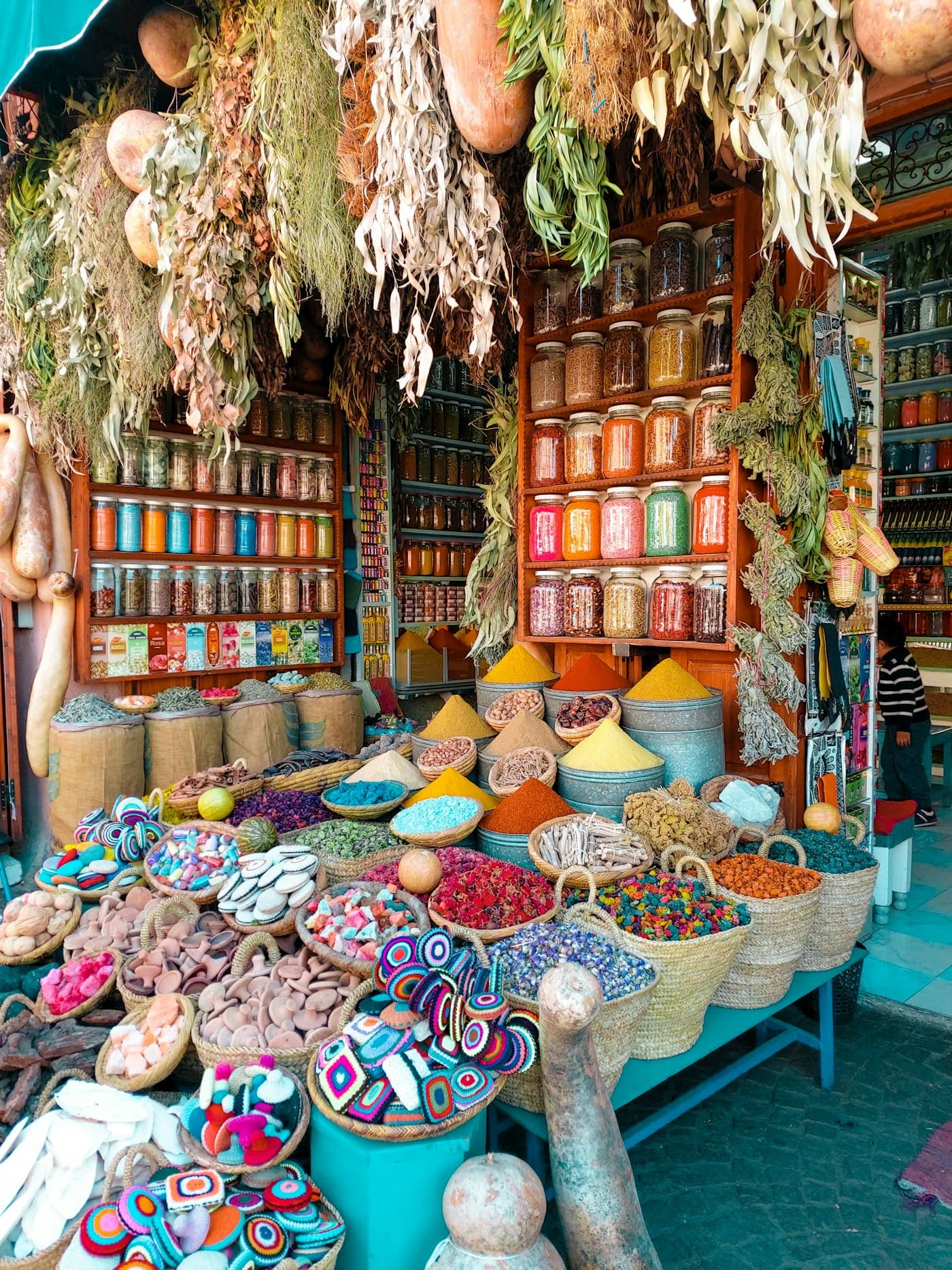 Pyramids of coloured spices and pottery in a Marrakech souk
