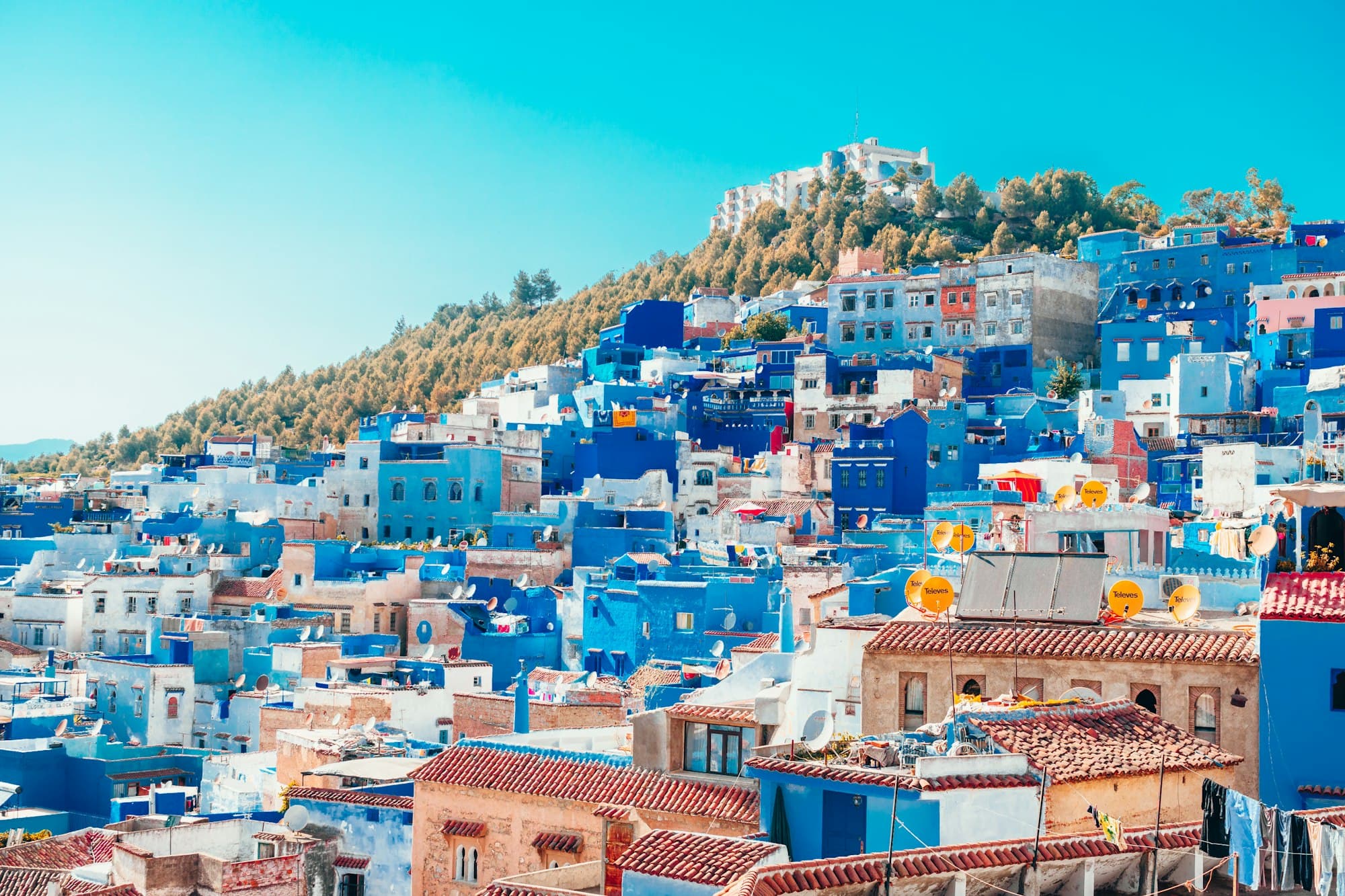 The blue-washed hillside town of Chefchaouen against the Rif Mountains