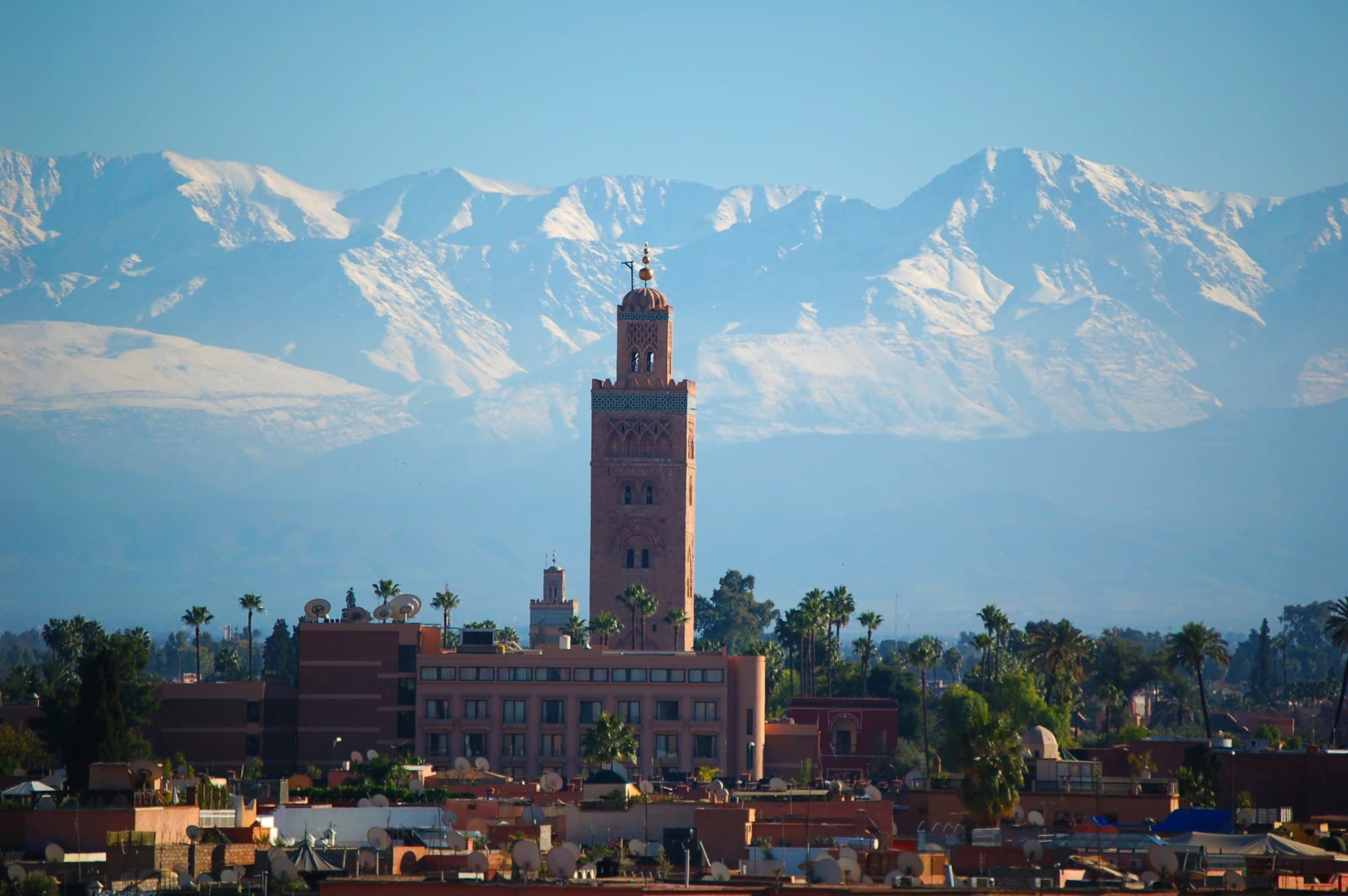 Marrakech skyline with the Koutoubia minaret and the snow-capped Atlas Mountains beyond